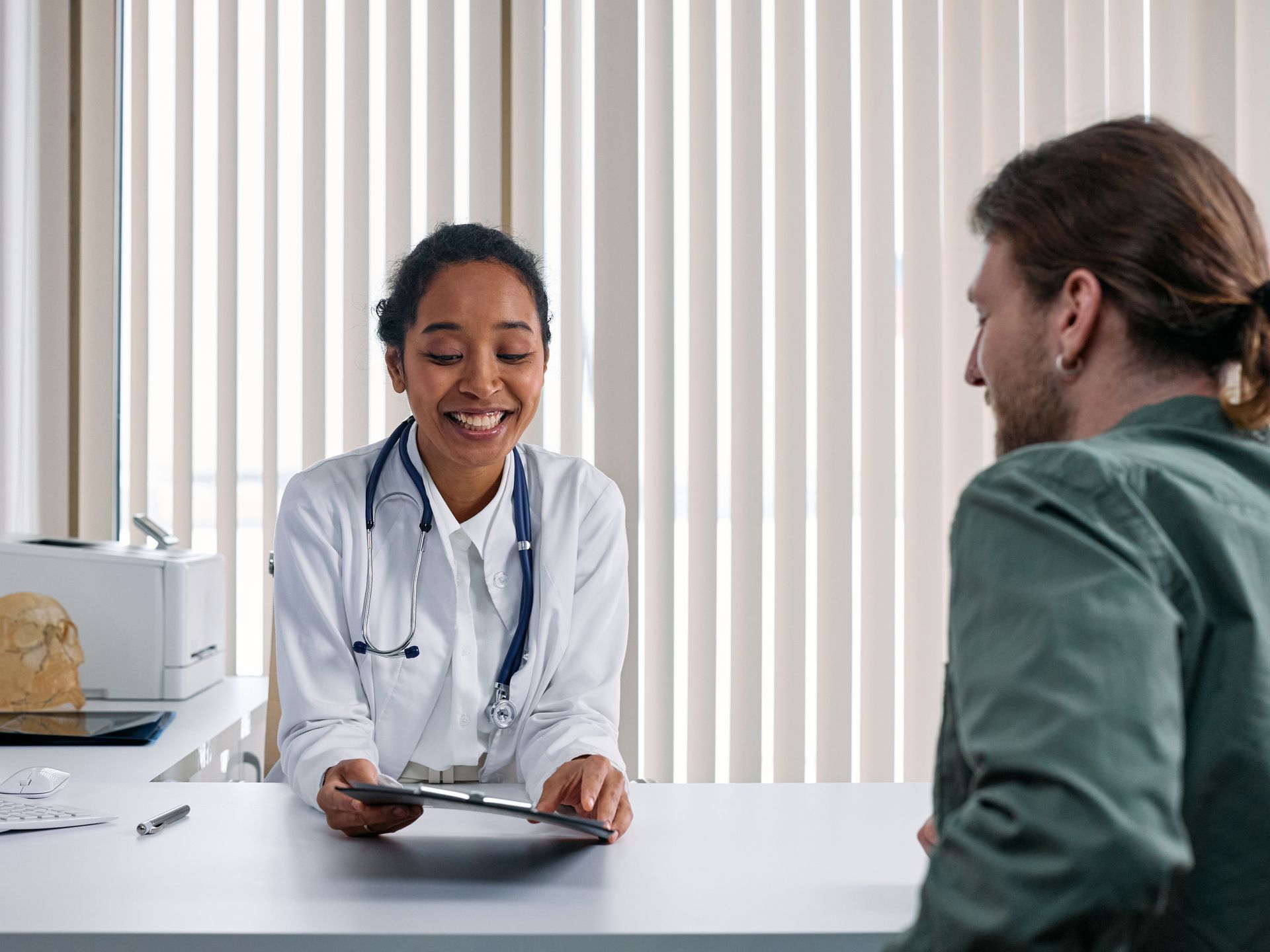 Doctor consulting with patient in a warm, private clinic setting at Laraib Health Clinic